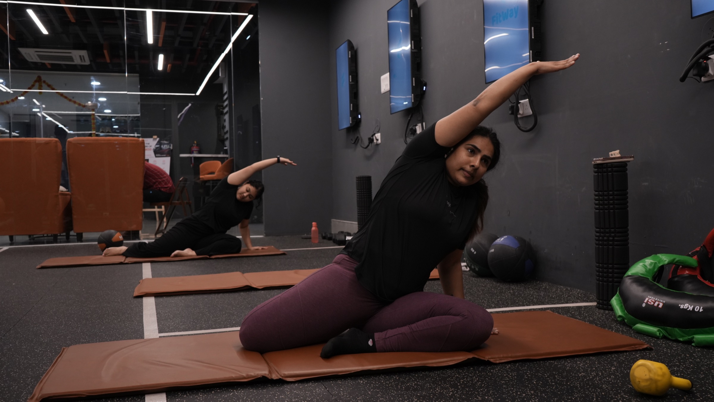 COREO member practising a Pilates side stretch