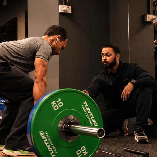 COREO coach guiding a member during a deadlift