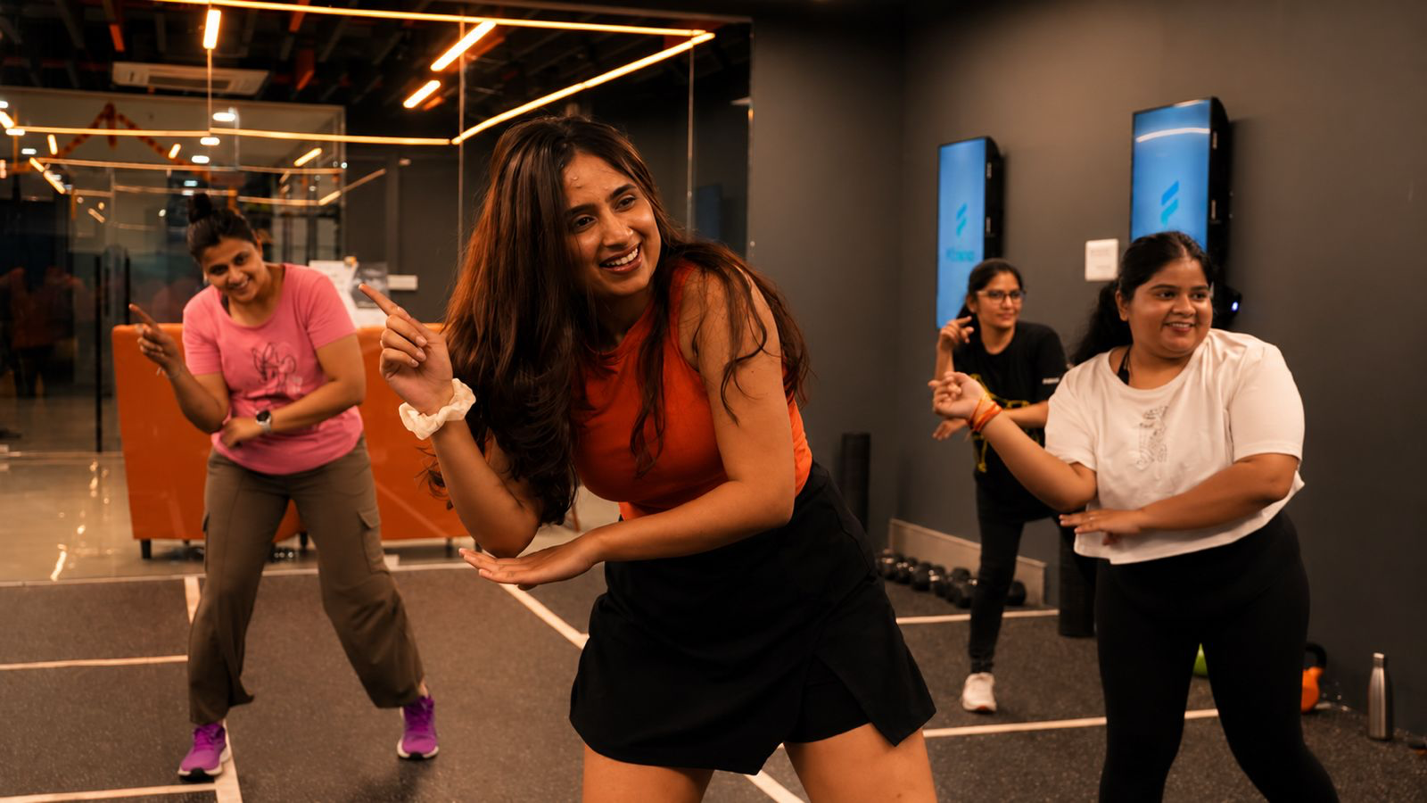 Zumba instructor leading a COREO dance class